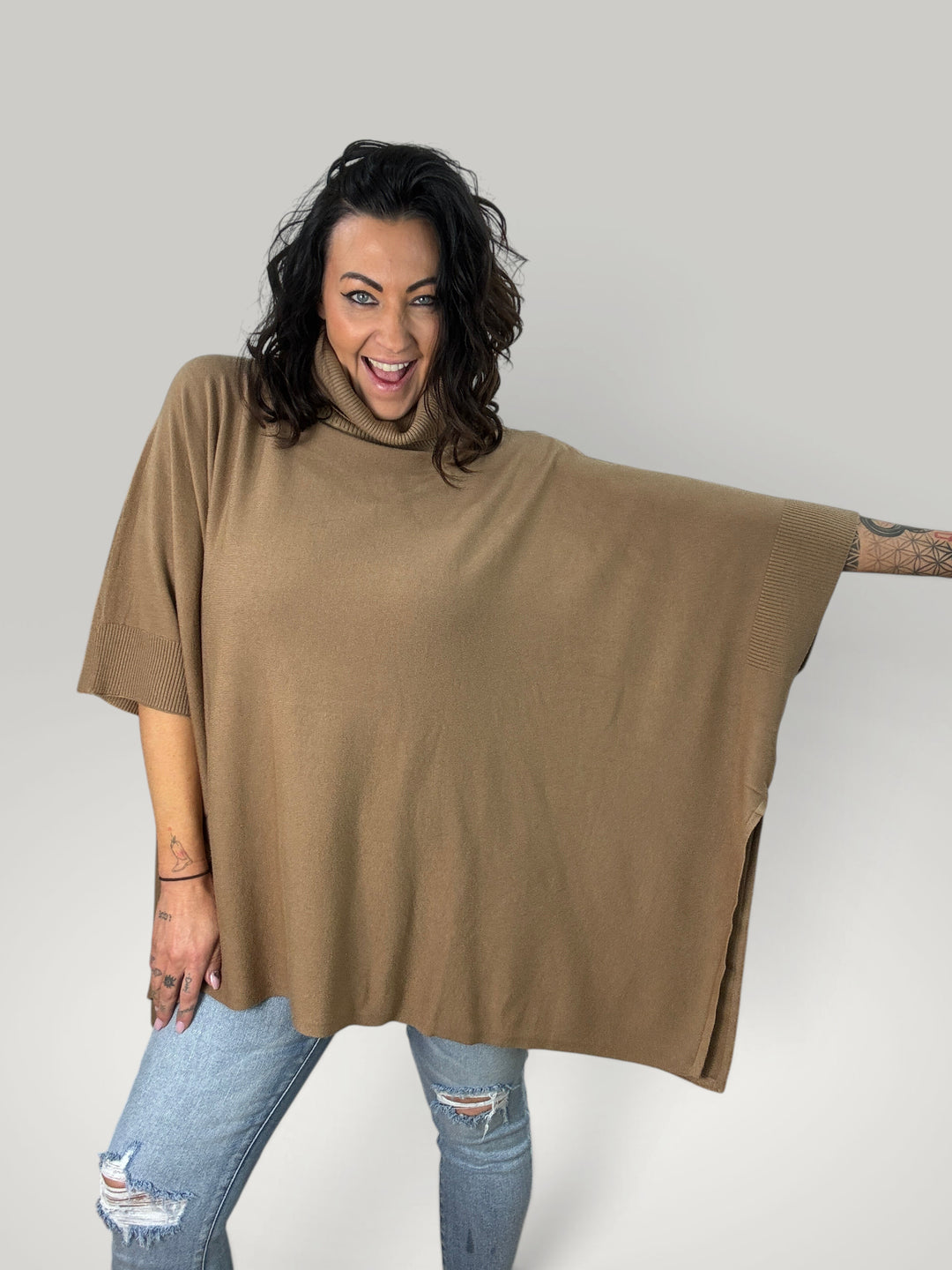 Modelo a usar poncho Isabelle Hannover castanho oversized com gola alta e mangas curtas em malha macia